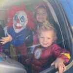 three children dressed in costume for halloween