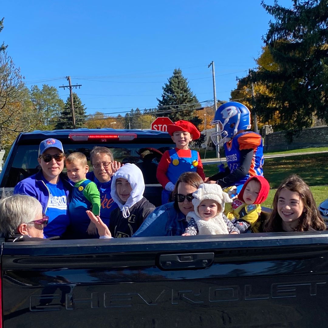 children and adults in back of truck for halloween drive through event