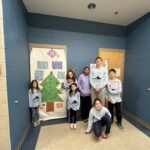 winter campers with their decorated door