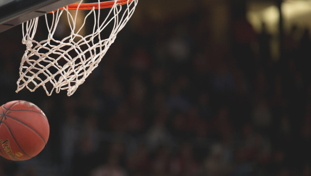 close up basketball going through hoop