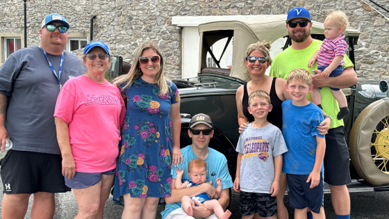 Coyle family in front of Bill Coyle's classic car