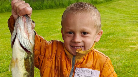 young boy with bass fishing at lake royer